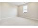 Well-lit bedroom featuring light carpet and a window view at 5566 Hickory Oaks Trl, Castle Rock, CO 80104