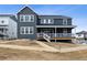 Two-story home with gray siding and large deck at 5566 Hickory Oaks Trl, Castle Rock, CO 80104
