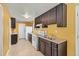 Bright kitchen with dark wood cabinets, granite countertops, and white appliances at 293 Mountain View Dr, Idaho Springs, CO 80452