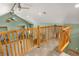 Loft area with wood railing and access to a bedroom at 26196 Rea Ave, Conifer, CO 80433