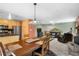 Open concept dining room with access to kitchen and living room at 26196 Rea Ave, Conifer, CO 80433