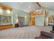 Two-story living room with loft and wood-burning stove at 26196 Rea Ave, Conifer, CO 80433