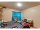 Bright bedroom with a queen bed and adjacent bathroom access at 8047 Wolff St # F, Westminster, CO 80031