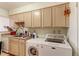 Galley kitchen includes washer, dryer and lots of storage at 8047 Wolff St # F, Westminster, CO 80031