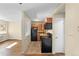 Modern kitchen with black appliances and wood cabinets at 5995 E Iliff Ave # 317, Denver, CO 80222