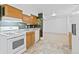 Functional kitchen with wood cabinets and white appliances at 4455 S Delaware St, Englewood, CO 80110