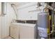 Basement laundry room with washer, dryer and water heater at 4455 S Delaware St, Englewood, CO 80110