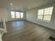 Bright living room with hardwood floors and large windows at 4823 Astor Pl, Brighton, CO 80601