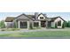 Two-story home with stone and shingle exterior, landscaping, and a paved driveway at 6178 Oxford Peak Ln, Castle Rock, CO 80108