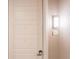 Residential unit entry door with keyless entry and modern light fixture at 12983 W Ida Ave # 310, Littleton, CO 80127