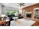 Spacious living room featuring a brick fireplace and ample natural light at 5627 S Idalia St, Centennial, CO 80015