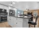 Open concept kitchen boasting a sizable island, stainless steel appliances, and breakfast bar at 5552 Flanders Way, Denver, CO 80249