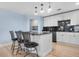 Updated kitchen featuring a large island with seating and light blue walls at 5552 Flanders Way, Denver, CO 80249