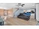 Open living room with hardwood floors, showing the kitchen, stairs, and a comfortable couch at 5552 Flanders Way, Denver, CO 80249