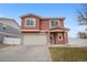 Two-story stucco home with attached garage and front yard at 5552 Flanders Way, Denver, CO 80249