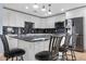 Modern kitchen with white cabinets, granite countertops, and stainless steel appliances at 5552 Flanders Way, Denver, CO 80249