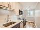 Updated kitchen, featuring stainless steel appliances and white cabinets at 969 S Pearl St # 204, Denver, CO 80209