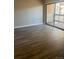 Living room with vinyl flooring and sliding door to patio at 10742 E Exposition Ave # 225, Aurora, CO 80012