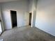 Spacious carpeted bedroom with closet and access to a bathroom at 17136 E Tennessee Dr, Aurora, CO 80017