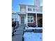 Brick townhouse exterior with balcony, steps, and snowy landscaping at 17136 E Tennessee Dr, Aurora, CO 80017
