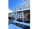 Brick townhouse exterior with balcony, steps, and snowy landscaping at 17136 E Tennessee Dr, Aurora, CO 80017