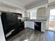 Galley kitchen with black appliances and granite countertops at 17136 E Tennessee Dr, Aurora, CO 80017