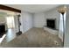 Living room with fireplace, carpet, and view into kitchen at 17136 E Tennessee Dr, Aurora, CO 80017