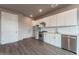 Modern kitchen with white cabinets and stainless steel appliances at 12983 W Ida Ave # 309, Littleton, CO 80127