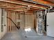 Unfinished basement with exposed plumbing and water heater at 8311 Ogden St, Denver, CO 80229