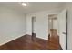 Bedroom with hardwood floors and access to hallway at 8311 Ogden St, Denver, CO 80229