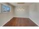 Light-filled dining room with hardwood floors and modern light fixture at 8311 Ogden St, Denver, CO 80229