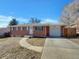 Brick ranch home with attached garage and landscaped yard at 8311 Ogden St, Denver, CO 80229