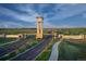 Aerial view of The Aurora Highlands entrance with a clock tower and landscaping at 3825 N Elk St, Aurora, CO 80019