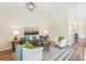 Living room with hardwood floors, white armchairs and large art piece at 2206 E 97Th Ave, Thornton, CO 80229