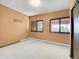 Finished basement bedroom with carpet, windows and baseboard heating at 1359 Pomegranate Ln, Golden, CO 80401