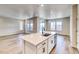 Kitchen island with white cabinets and quartz countertops at 23902 E 40Th Ave, Aurora, CO 80019