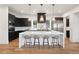 Modern kitchen with white island and dark cabinets at 2504 Zenobia St, Denver, CO 80212