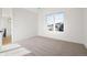 Bright bedroom with carpeted floor and large window offering natural light at 2504 Zenobia St, Denver, CO 80212