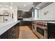 Sleek kitchen showcasing stainless steel appliances and dark cabinetry at 2504 Zenobia St, Denver, CO 80212