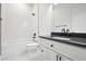 Modern bathroom with white tile, black fixtures, and a dark countertop at 2504 Zenobia St, Denver, CO 80212