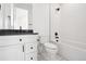 Clean bathroom with white vanity, dark countertop, and black fixtures at 2504 Zenobia St, Denver, CO 80212