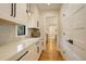 Butlers pantry with white cabinets, quartz countertops, and a window at 1930 Albion St, Denver, CO 80220