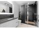 Modern bathroom with dark tile and a glass-enclosed shower at 4200 W 17Th Ave # 618, Denver, CO 80204
