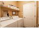 Laundry room with washer, dryer, and shelving at 4961 Aspen Creek Dr, Broomfield, CO 80023