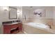 Spa-like bathroom with soaking tub and dark marble vanity at 1891 Curtis St # 1613, Denver, CO 80202