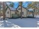 Side view of a house with a porch and snow at 30232 Hilltop Dr, Evergreen, CO 80439