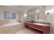 Elegant bathroom with double vanity, soaking tub, and separate shower at 1891 Curtis St # 1613, Denver, CO 80202