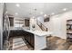 Modern kitchen with a large island, stainless steel appliances, and stylish pendant lights at 2555 Mayotte Way, Castle Rock, CO 80109