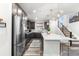 Modern kitchen with a large island, stainless steel appliances, and stylish pendant lights at 2555 Mayotte Way, Castle Rock, CO 80109