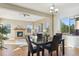 Dining area with dark wood table, leather chairs and living room view at 10607 Rutledge St, Parker, CO 80134